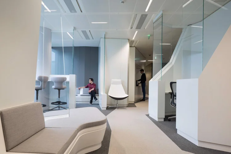 Thales executive lounge with sculptural white seating and glass partitions