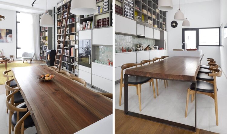 Solid walnut dining table with wishbone chairs seen against the library and kitchen
