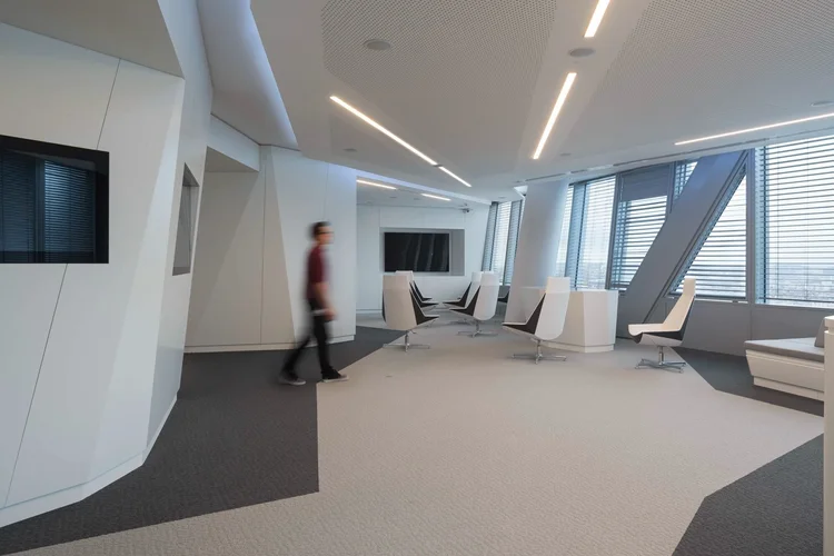 Thales light-filled lounge with geometric ceiling and angled tower windows