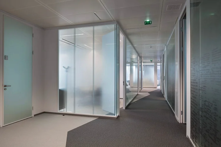 Thales corridor with frosted glass private offices and a diagonal floor pattern