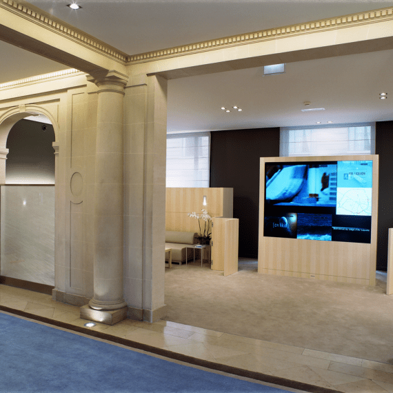 Air Liquide lobby with classical stone columns and a luminous digital wall