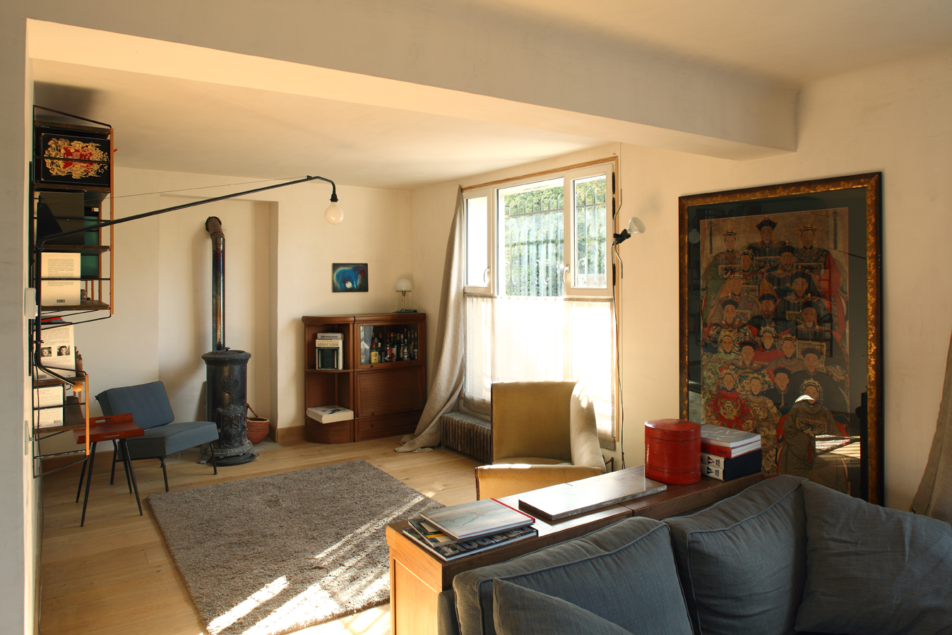 Living room with wood stove, oak floor and large framed Chinese painting