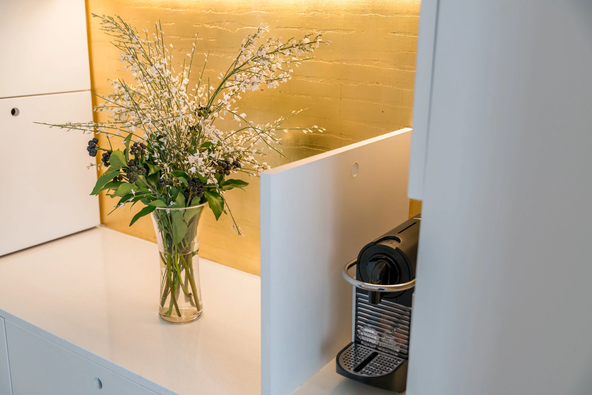 Narrow white kitchen along the corridor of a Paris duplex