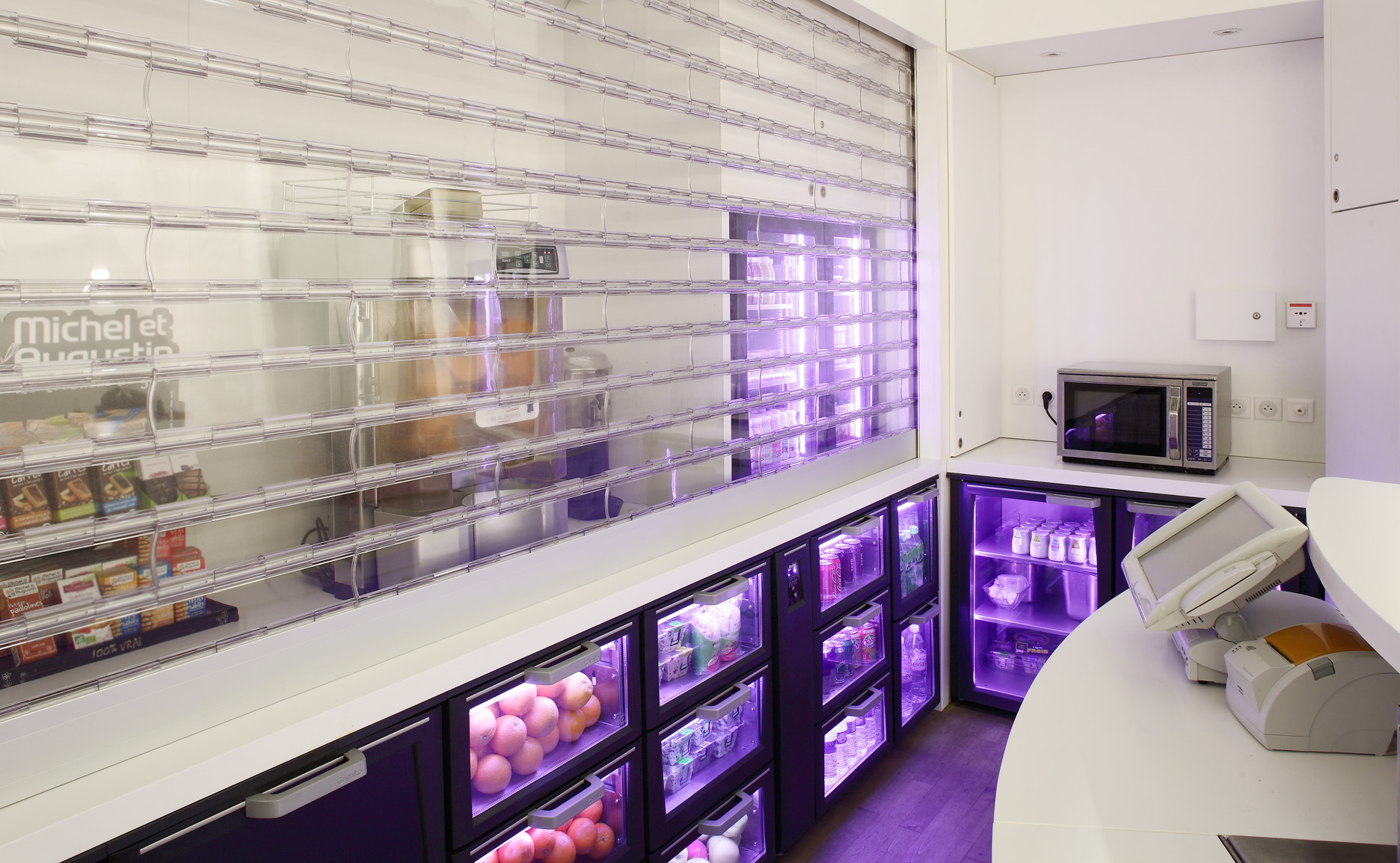 Self-service back bar with illuminated display drawers and violet lighting