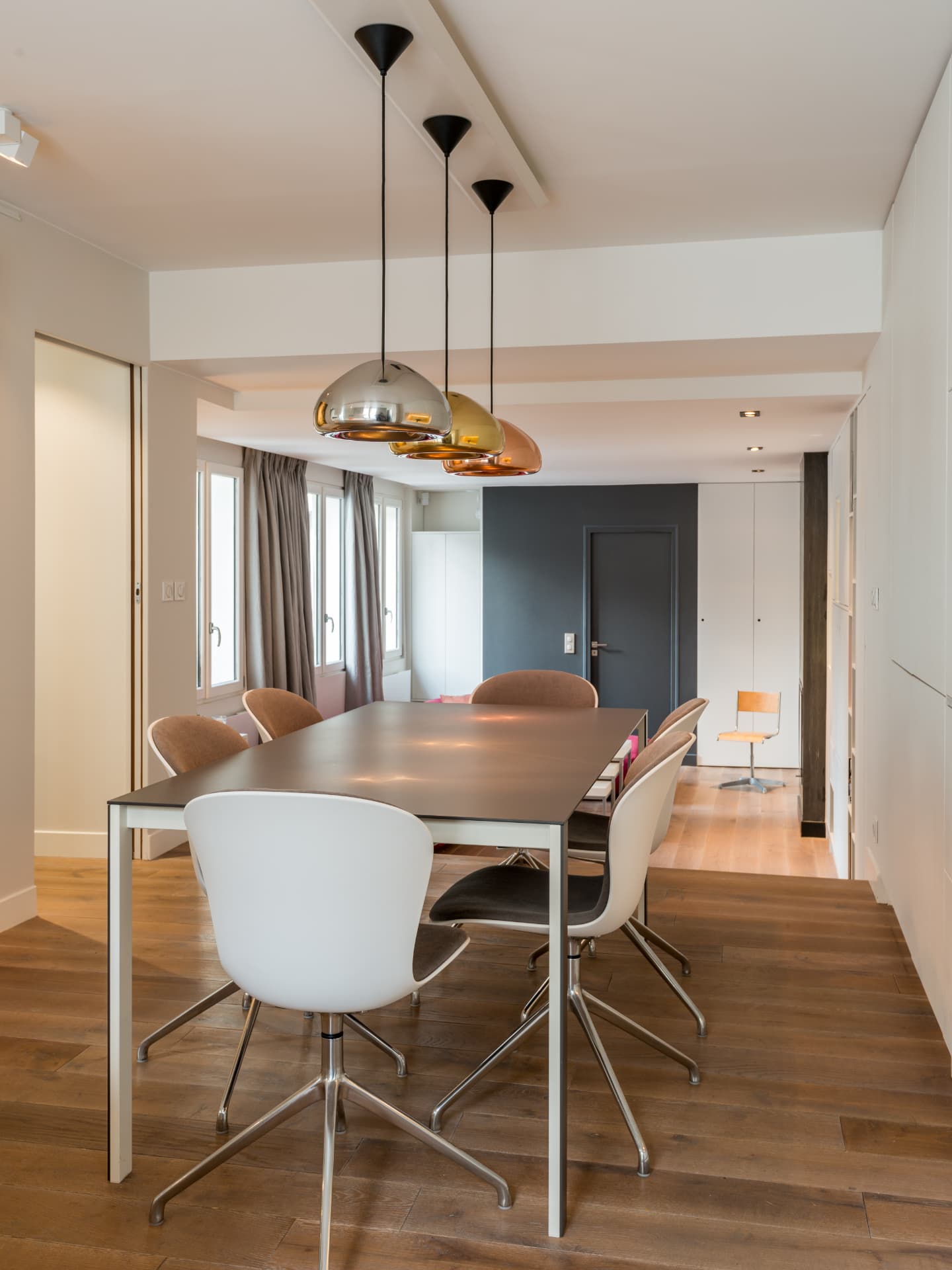 Dining room with a dark feature wall and oak parquet