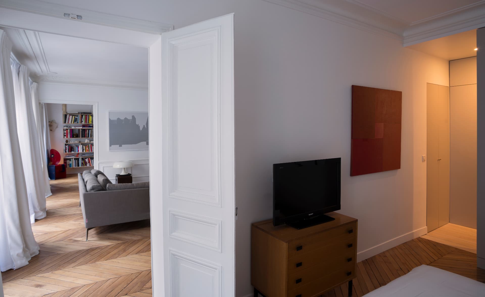 Bedroom looking through double doors into the living room