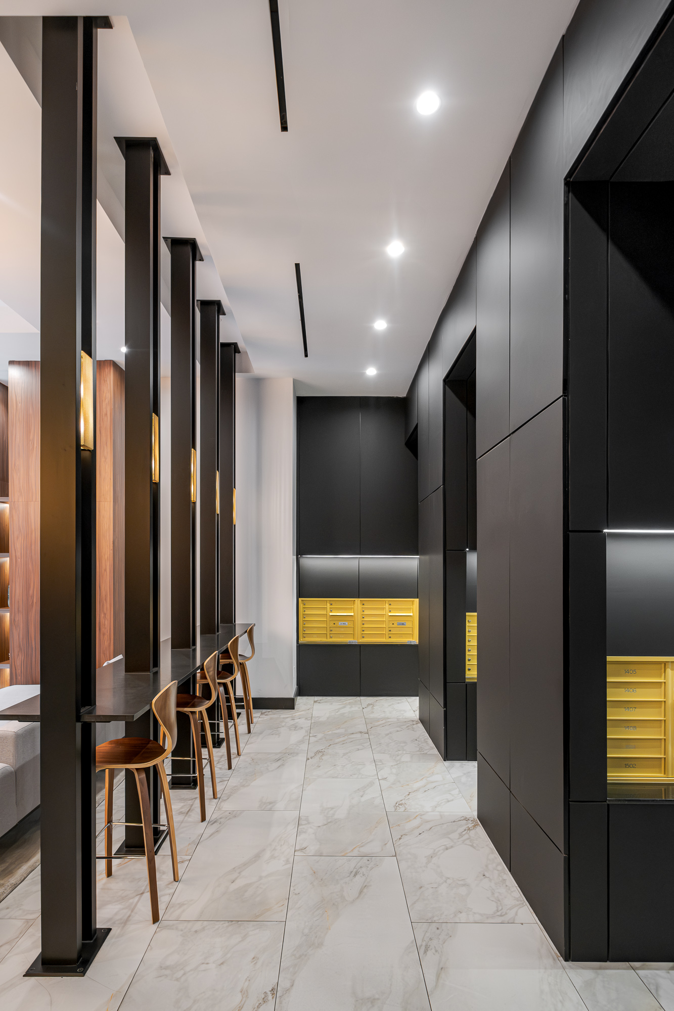Mail and package room with black joinery and brass lockers