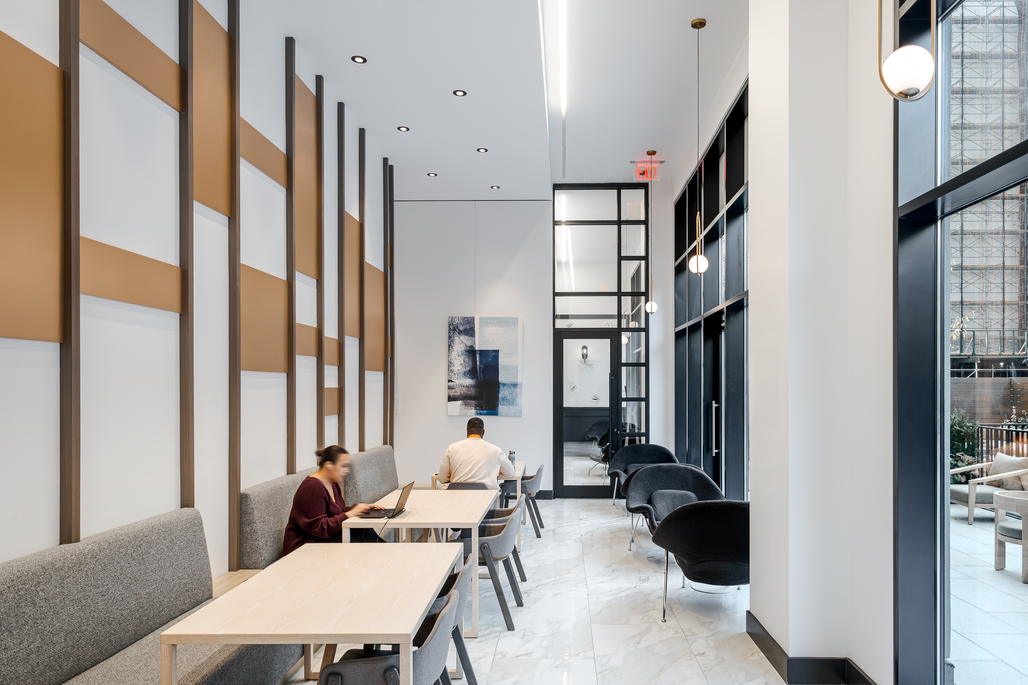 Co-working room with banquette seating and tan wall panelling
