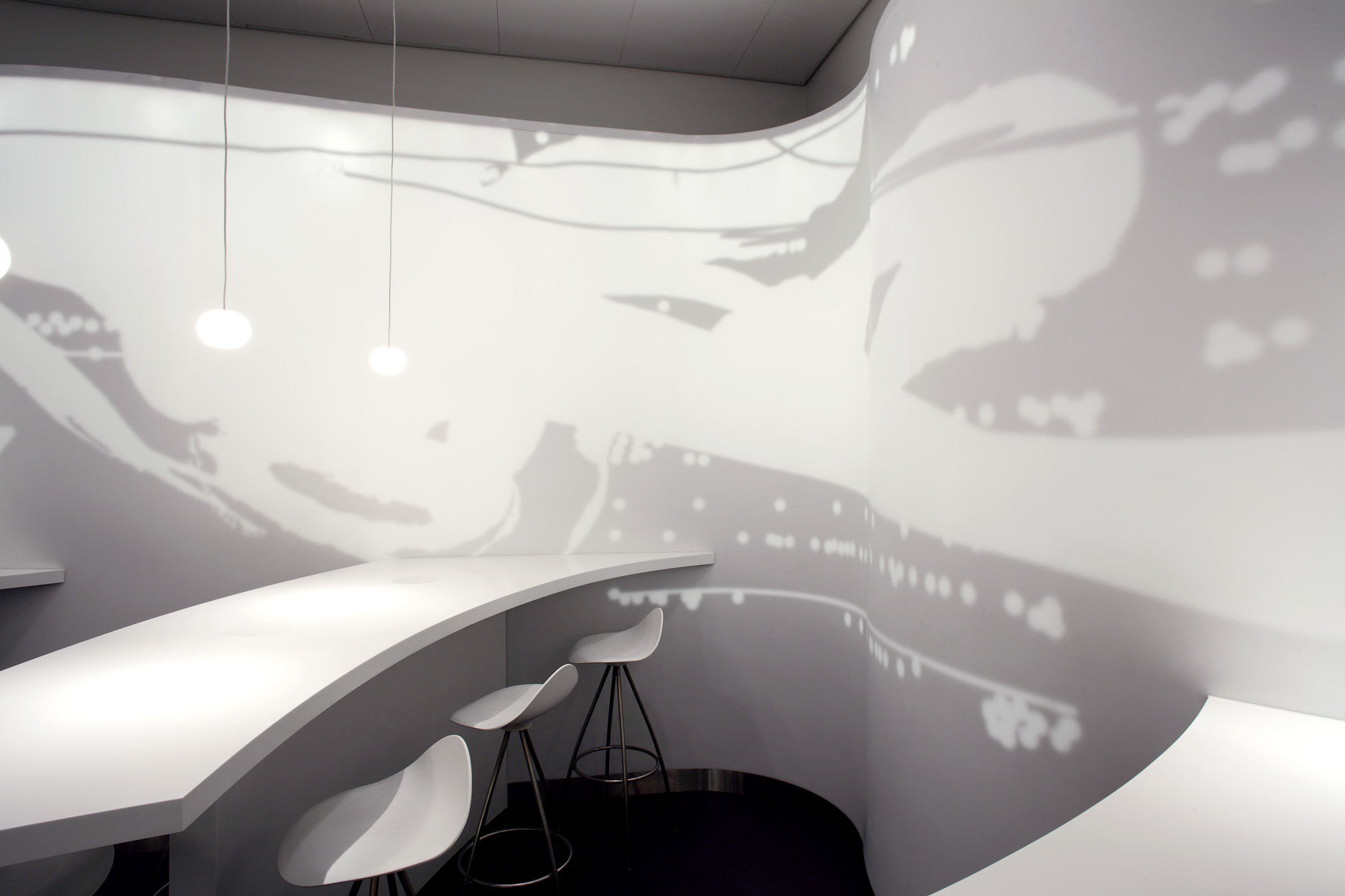 Curved white counter wrapping a column with aviation-inspired wall graphics