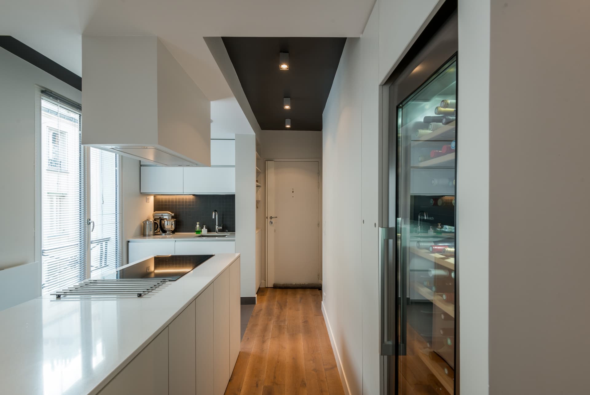 Long view through the kitchen corridor to the entry door