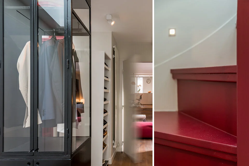 Lacquered red stair rising between white walls