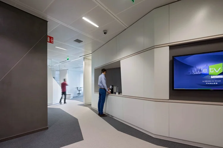 Thales catering point with white millwork and a digital welcome screen