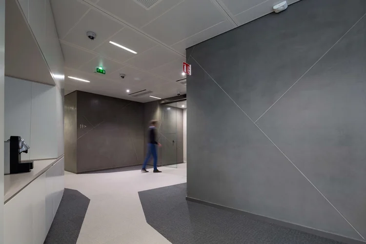 Thales corridor with grey textured walls and a soft geometric floor pattern